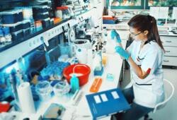 A picture of a woman sitting in a laboratory. A picture of a woman sitting in a laboratory.