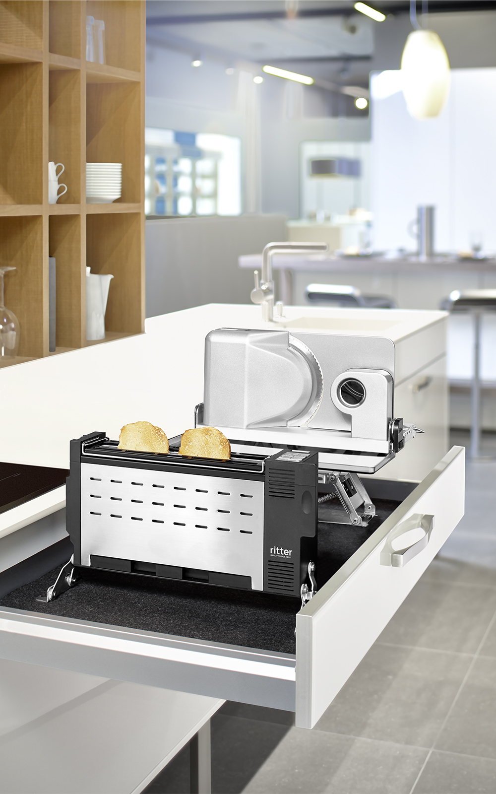 A picture of a built-in combination of a built-in food slicer and an electric toaster toasting bread that comes out of a kitchen drawer. A picture of a built-in combination of a built-in food slicer and an electric toaster toasting bread that comes out of a kitchen drawer.