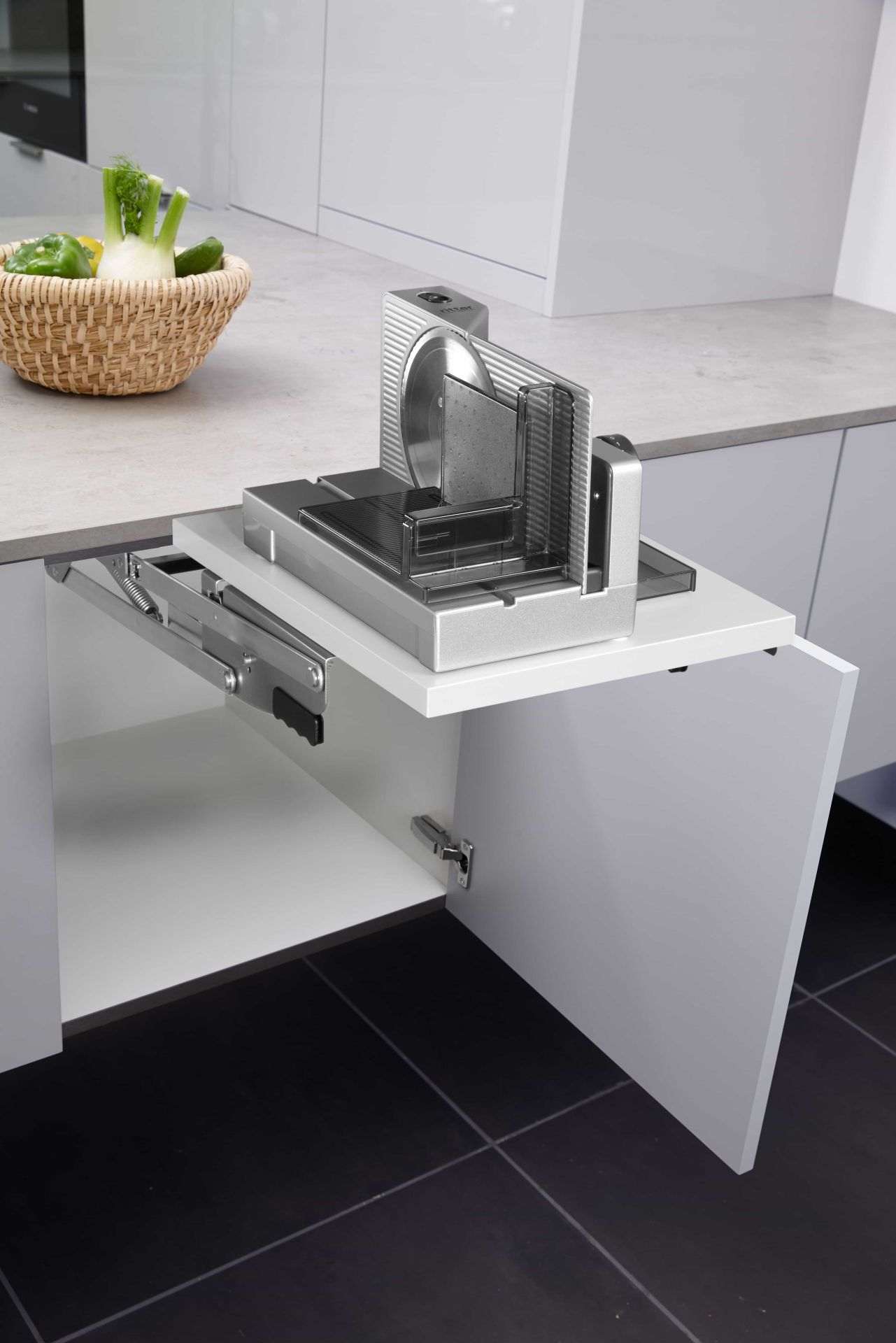 Side view of the built-in food slicer in the kitchen, in base unit