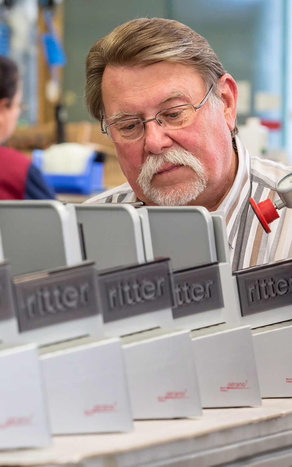 A picture of a man assembling all-purpose slicers. A picture of a man assembling all-purpose slicers.