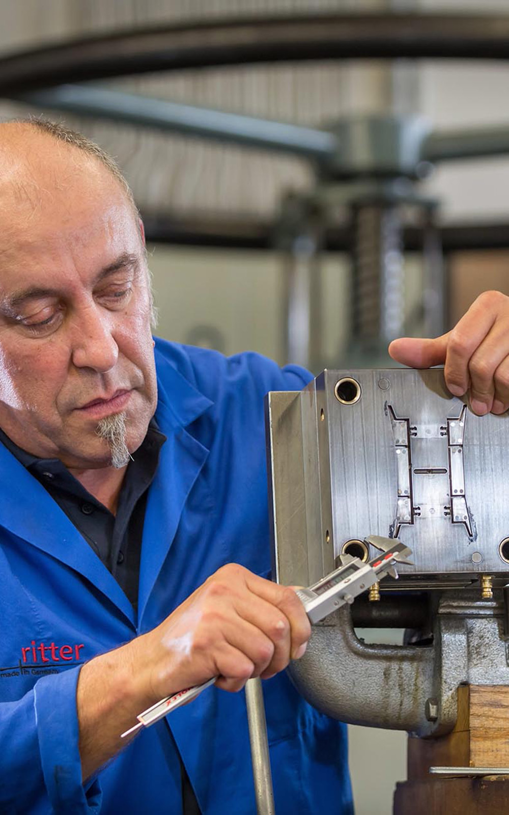 A picture of a man working on a machine. A picture of a man working on a machine.