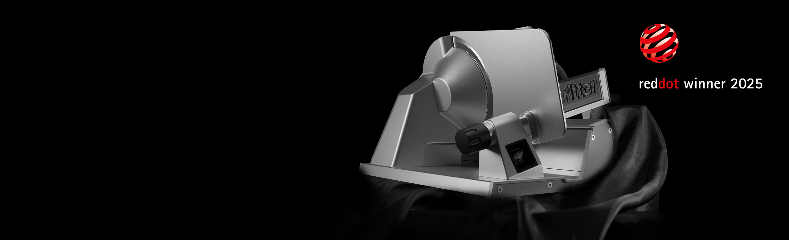 An image of a fine cutter emerging from a black cloth and a reddot winner 2025 award.