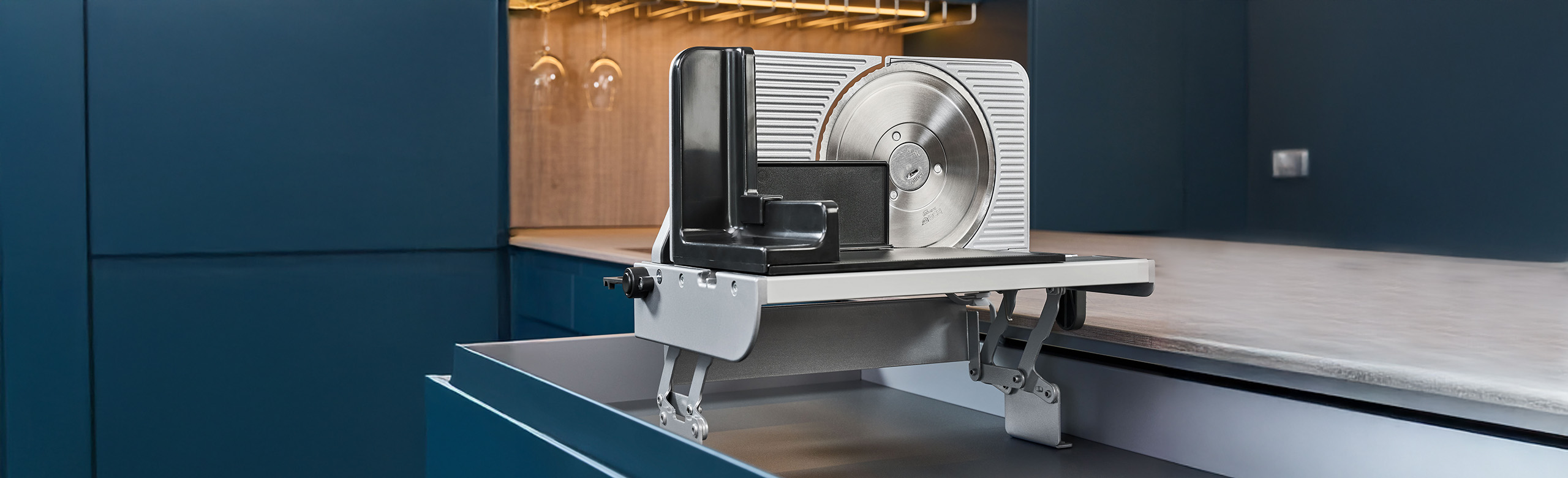 A picture of a built-in all-purpose slicer emerging from a kitchen drawer.